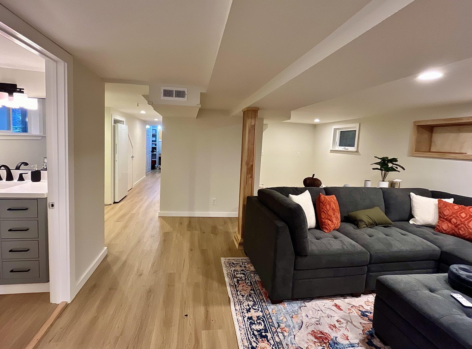 A front view of the basement to ADU conversion shows the bathroom and living room.