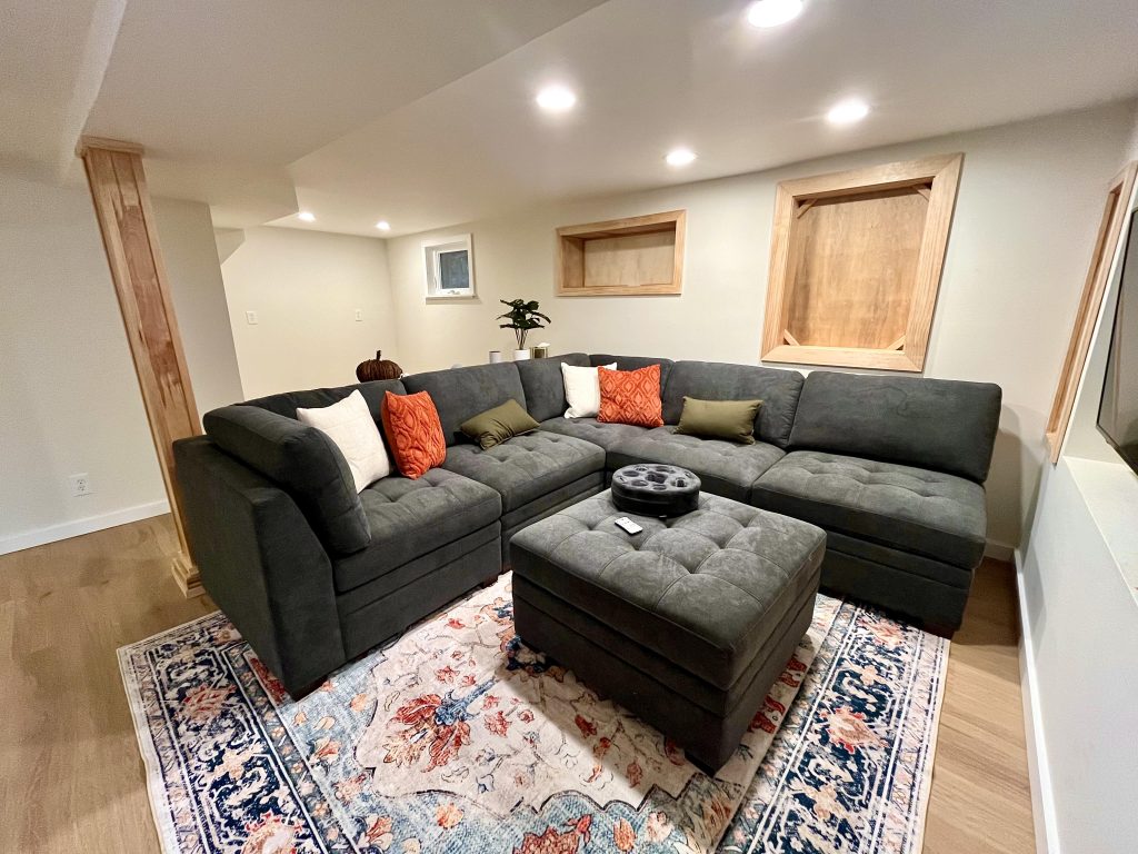 The living space of the ADU conversion includes built-in shelving and recessed lighting.