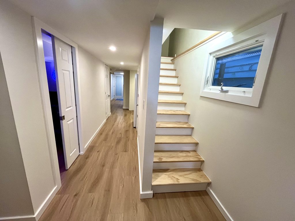 A newly-built staircase and hallway in a finished basement conversion.