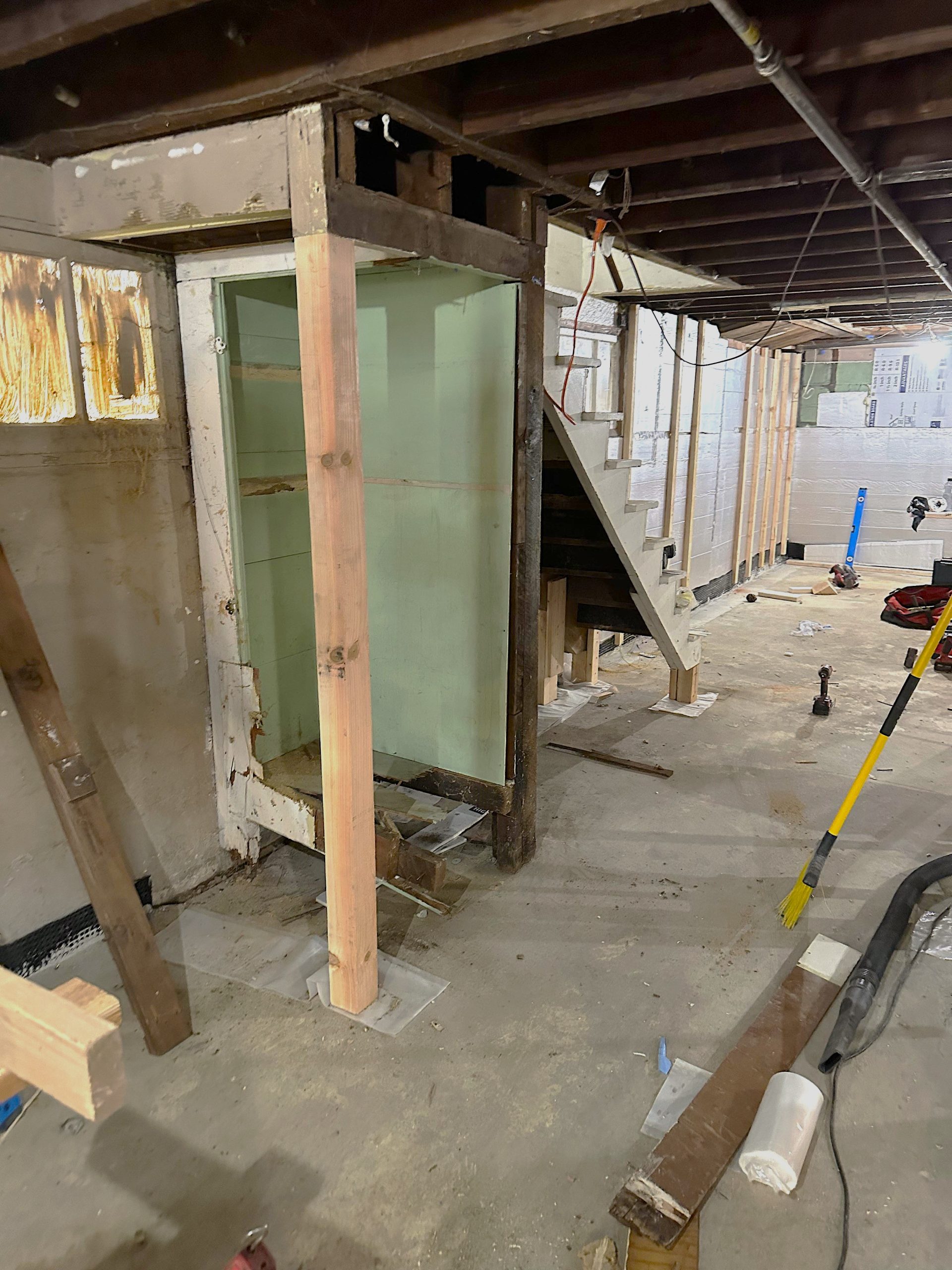 The original basement layout features a small space under the stairs that would be covered to form a hallway spanning the length of the ADU conversion.