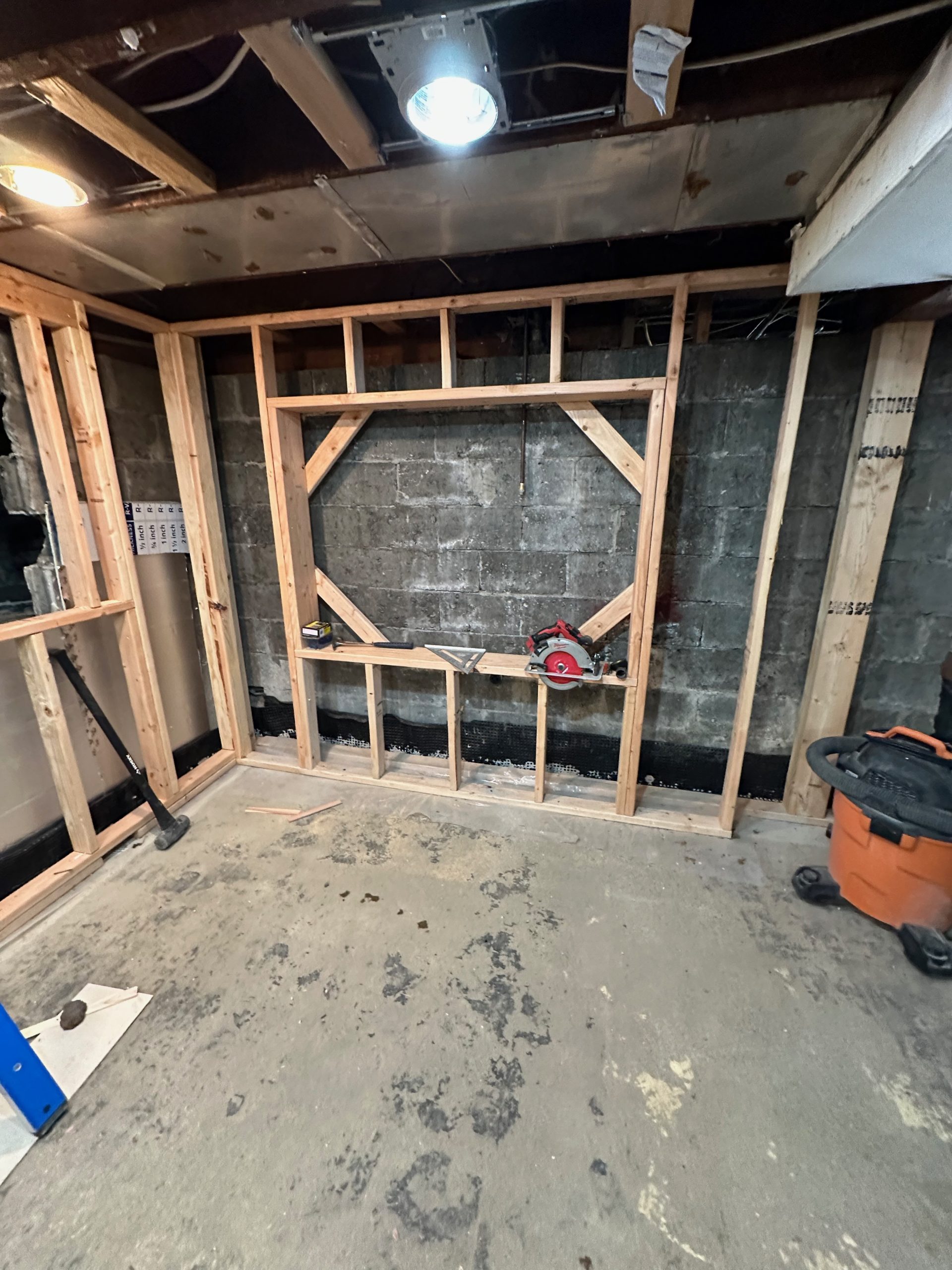 basement conversion process living room wall storage scaled