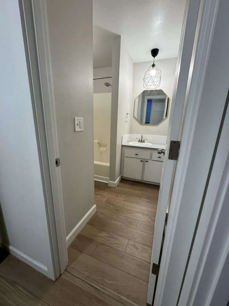 bathroom before remodel with wood look flooring