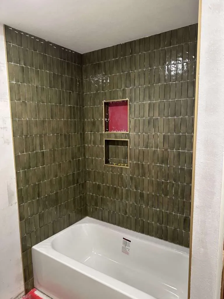 bathroom remodel with new tiled tub and shelving
