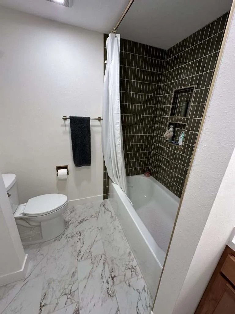 bathroom upgrade with marble tile floor and modern fixtures