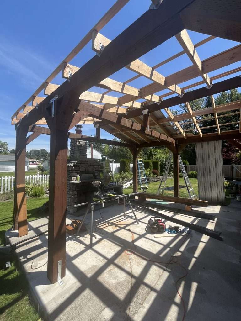 An angled view of the underside of a patio cover framing.