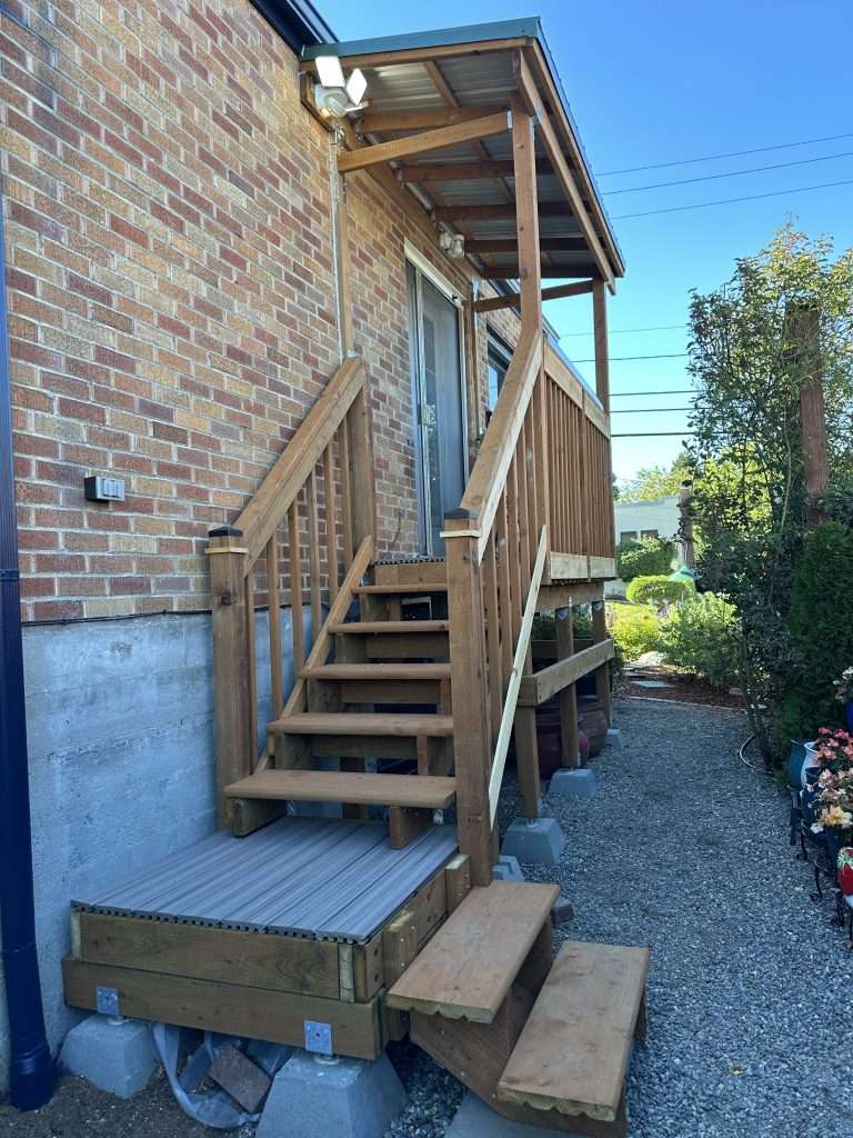 A front view of stairs to a newly built covered entry porch.