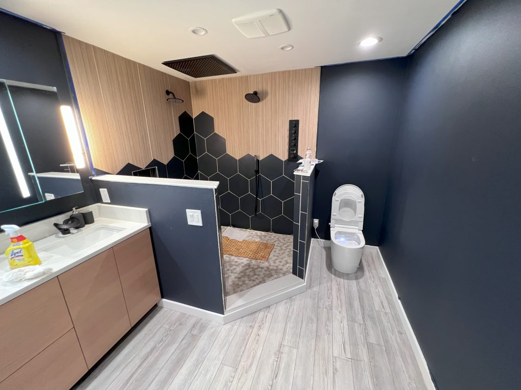 A master bathroom with a bidet toilet, walk-in shower, and vanity.
