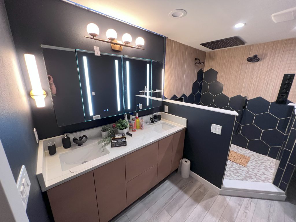 A master bathroom with a double vanity and custom-tiled walk-in shower.
