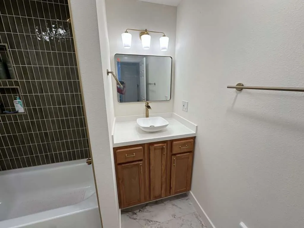 modern bathroom with marble flooring and vessel sink vanity