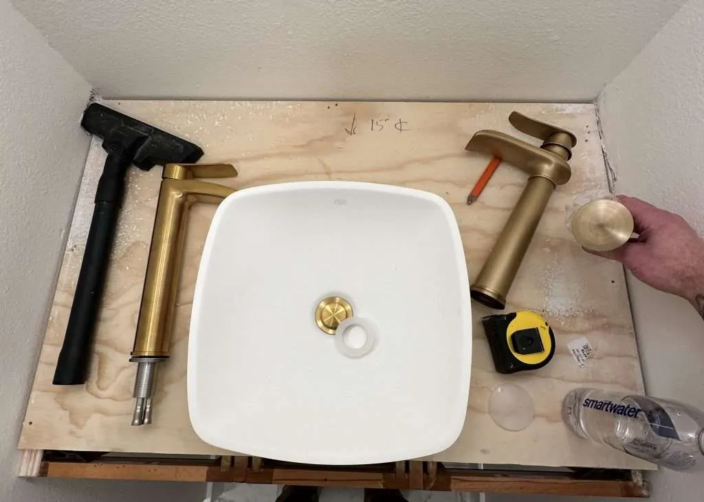 modern vessel sink and golden faucet installation