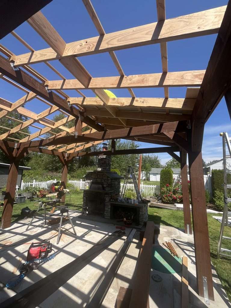 A bottom view of the framing for a custom patio cover.