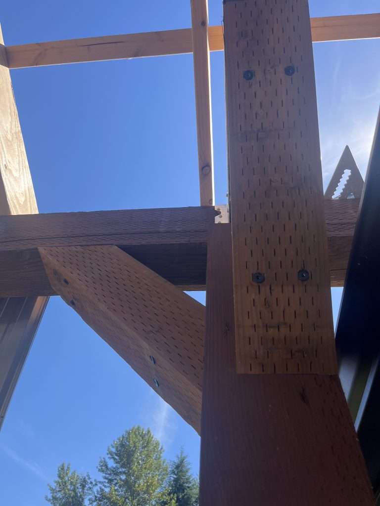 A close up view of a post and beam joinery for a custom patio cover.